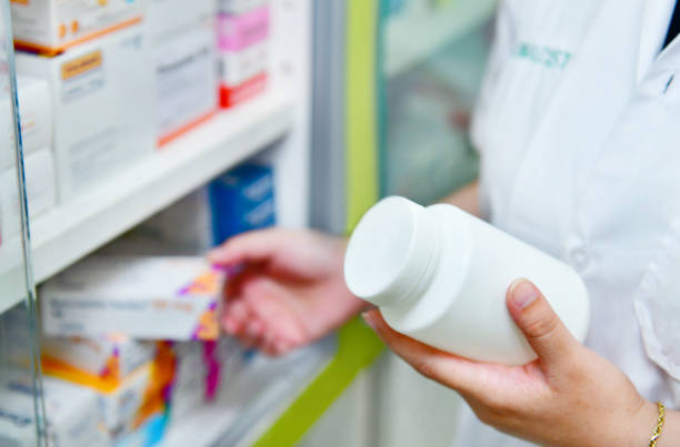 istock Pharmacist holding bottle and box of medicine 894848668