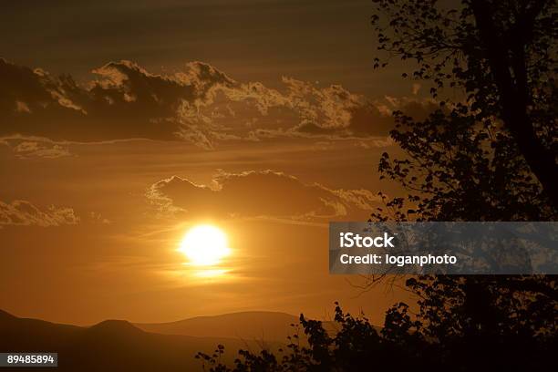 Sunset Through Clouds Stock Photo - Download Image Now - Cloud - Sky, Color Image, Gold Colored