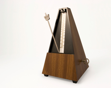 A studio shot of a mechanical metronome.
