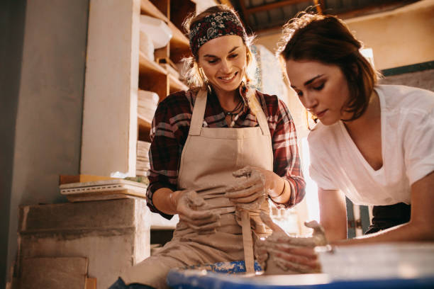 istock Woman teaching the art of pot making 894872530