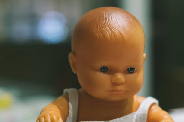 Isolated white doll boy toy inside a domestic home