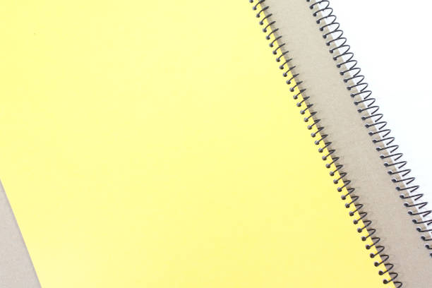 istock Yellow note book cover and brown note book on white background 894875322