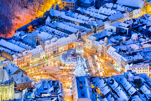 Brasov, Romania. Christmas Market in Main Square, with Xmas Tree and lights Transylvania landmark, Eastern Europe