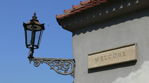 istock Welcome - stone tablet and lamp on the wall 89490164