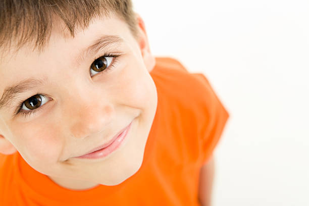 Photo of adorable young boy looking at camera 