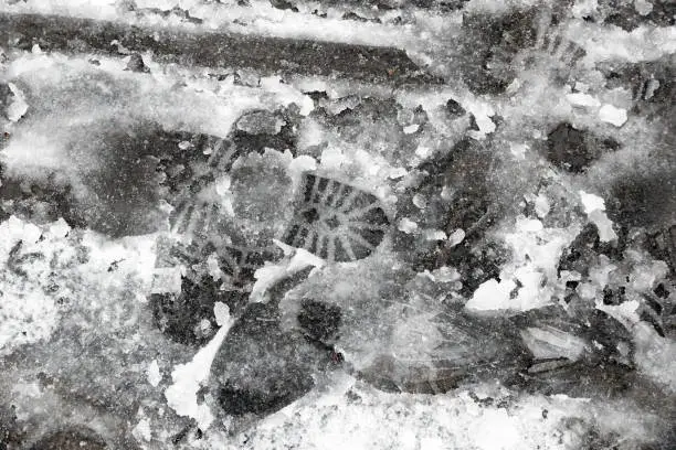 Footprints on slushy snow in London, UK