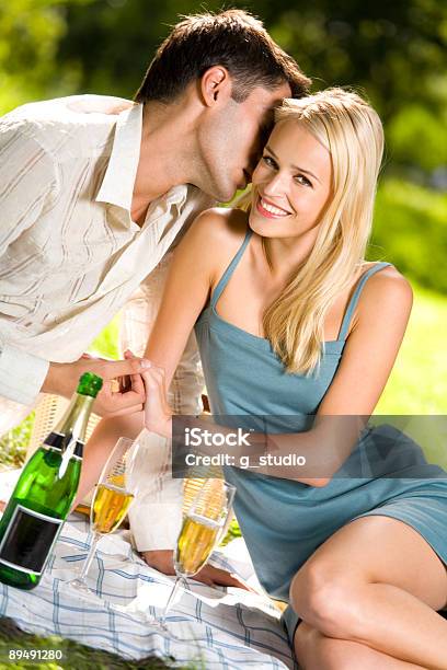 Young Couple Celebrating With Champagne Together At Picnic Stock Photo - Download Image Now