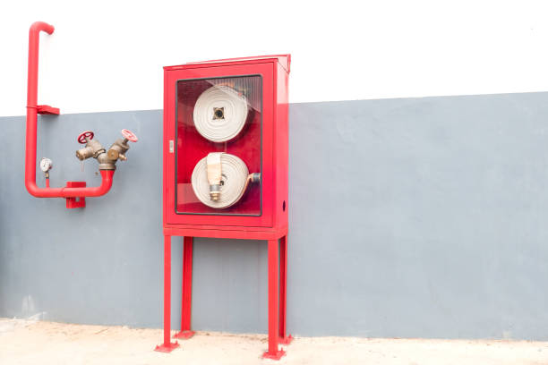 istock Red Cabinets for fire extinguishers Stick to the gray wall 894918678