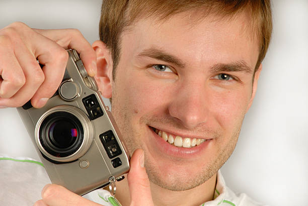 istock young man with  camera in hands, close up 89492159
