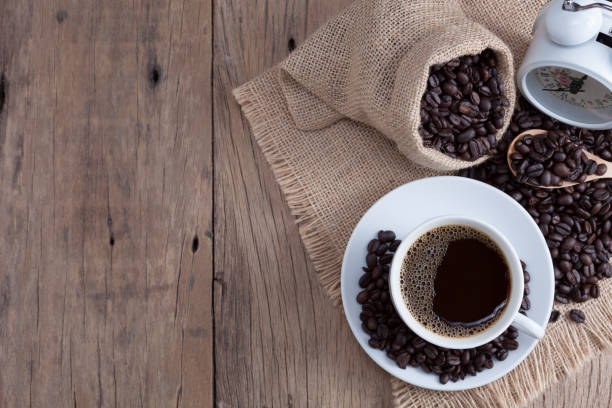 istock coffee cup and coffee beans on old wood plank background. 894922402