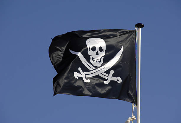 istock Pirate flag flying in blue sky 89492834