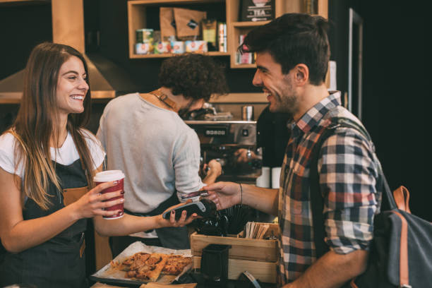 istock Customer paying with a credit card at a coffee shop 894931888