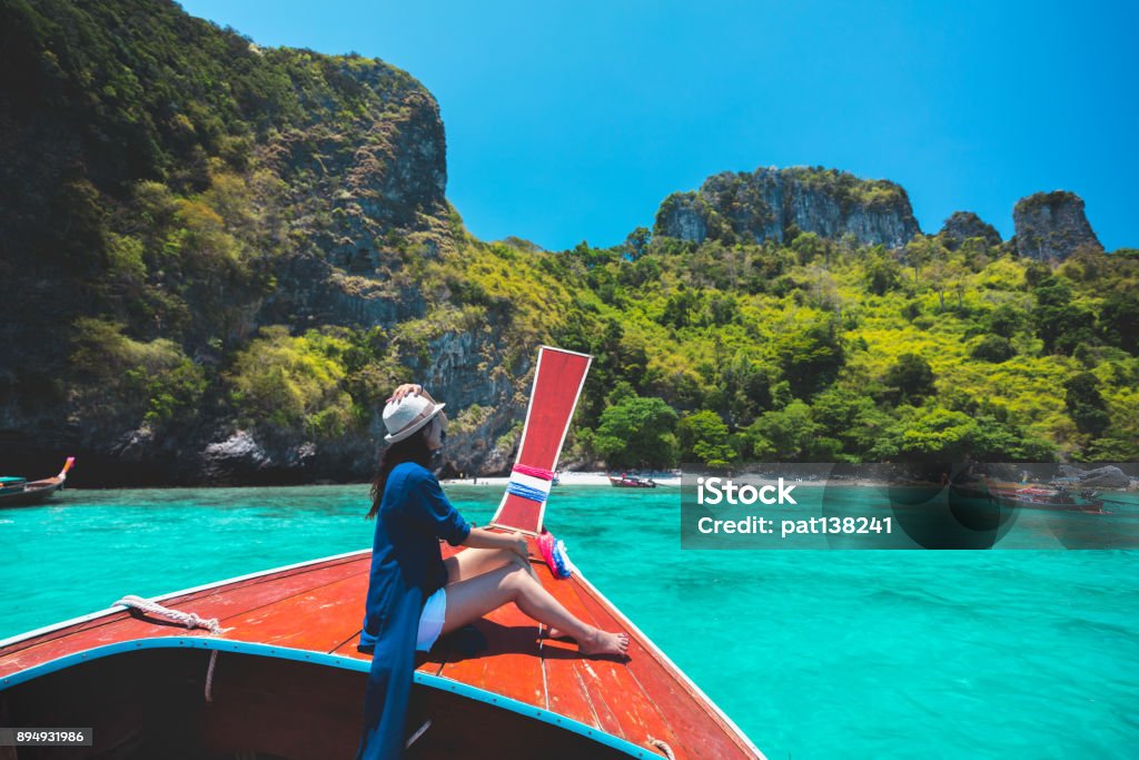 Happy female traveling on boat Happy female traveling on boat, Krabi Thailand Phuket Island Stock Photo