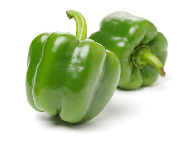 istock Two green bell peppers isolated on a plain white background 894932284