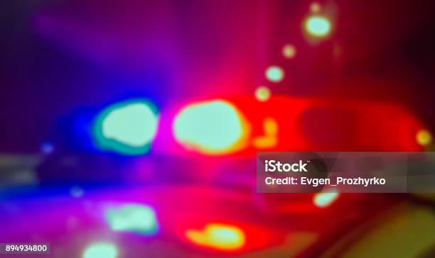 Lights Of Police Car In Night Time Crime Scene Night Patrolling The City Lights Flashing Abstract Blurry Image Stock Photo - Download Image Now