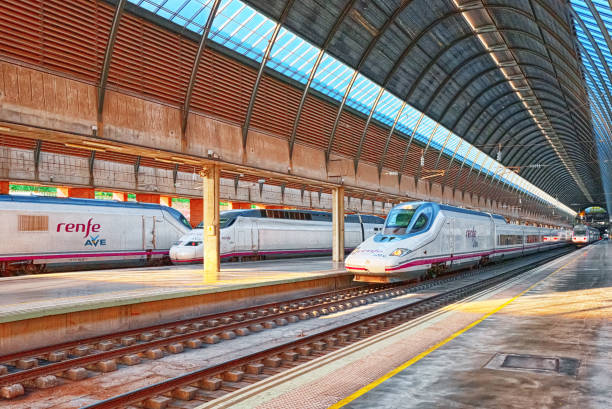 Modern hi-speed passenger train of Spanish railways company-Renfe, on Seville railways station Sevilla Santa Justa. Seville, Spain - June 10, 2017 : Modern hi-speed passenger train of Spanish railways company-Renfe, on Seville railways station Sevilla Santa Justa. seville port stock pictures, royalty-free photos & images