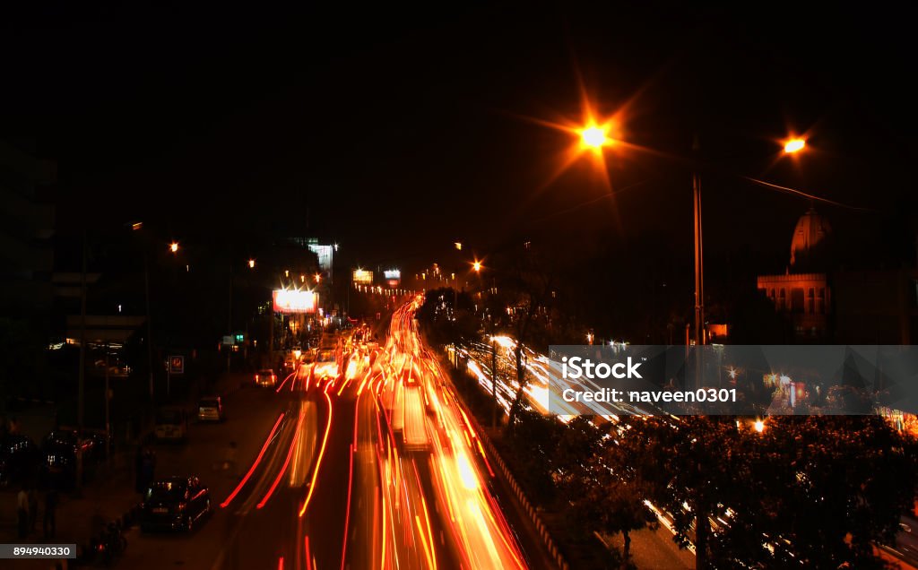 A busy road at night in New Delhi, India Traffic lights on a busy road in New Delhi, India Bangalore Stock Photo