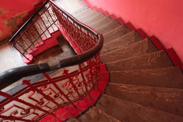 istock Spiral staircase in pink color 894940704