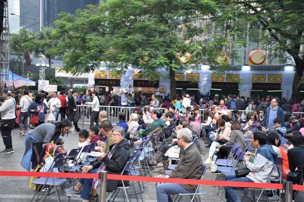 foule des peuples asiatiques s’asseoir devant un stade à chaozhou marché à hong kong - urban scene china city horizontal photos et images de collection