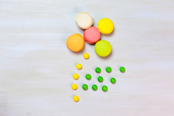 A flower making of macaroons and candies on a light background