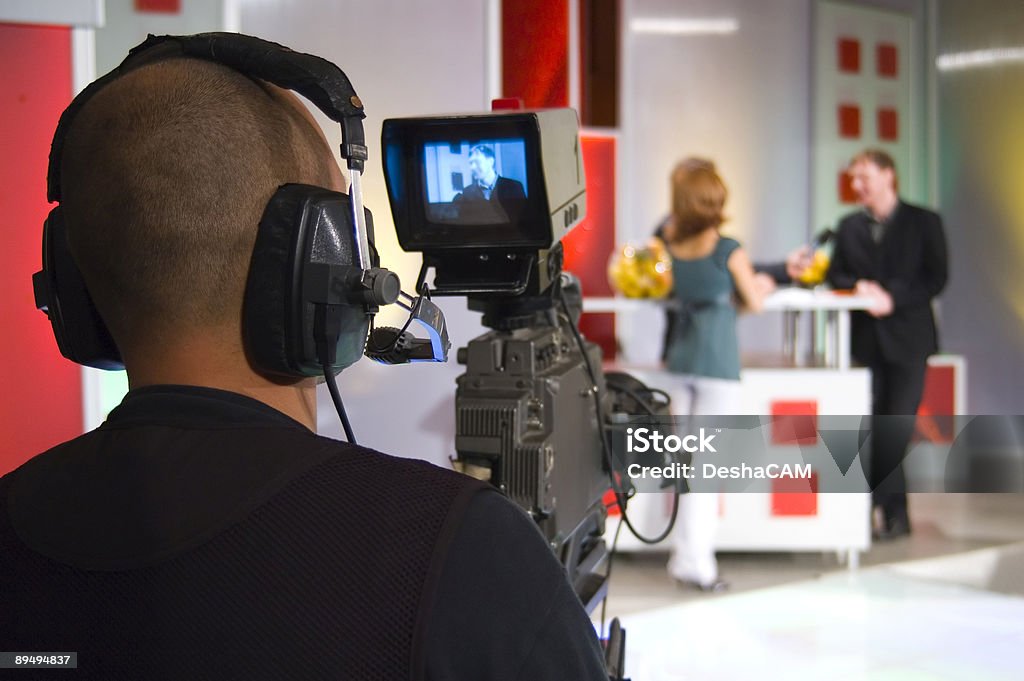 Camera man filming in TV studio Television video crew shoots the TV show, setting up a studio production. Camera Operator Stock Photo