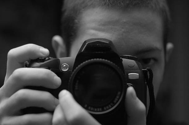 istock self portrait black and white young man with camera 89495656