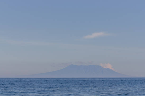 istock volcano on horizon and sea 894959138