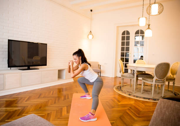 istock Fit young woman exsercise in the room 894963162