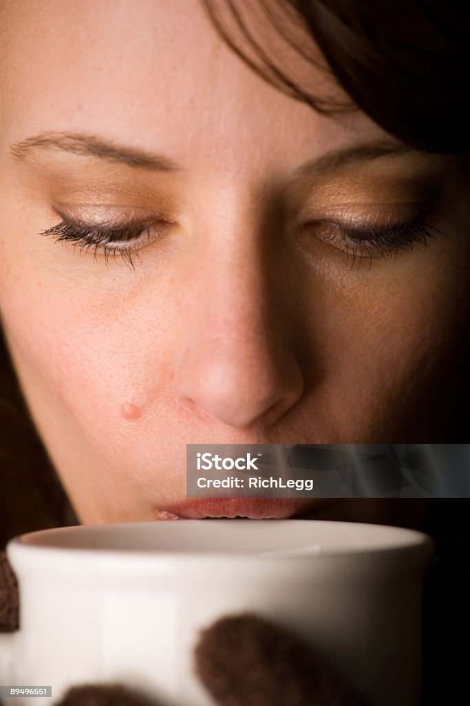 Brunette Series A close-up of a woman drinking a beverage from a cup. Adult Stock Photo