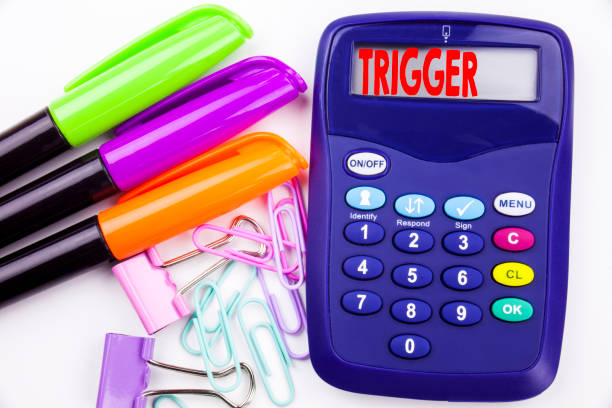 istock Writing word Trigger text in the office with surroundings marker, pen writing on calculator. Business concept for Stir Spark Loose or Unleash Idea white background with copy space 894965758