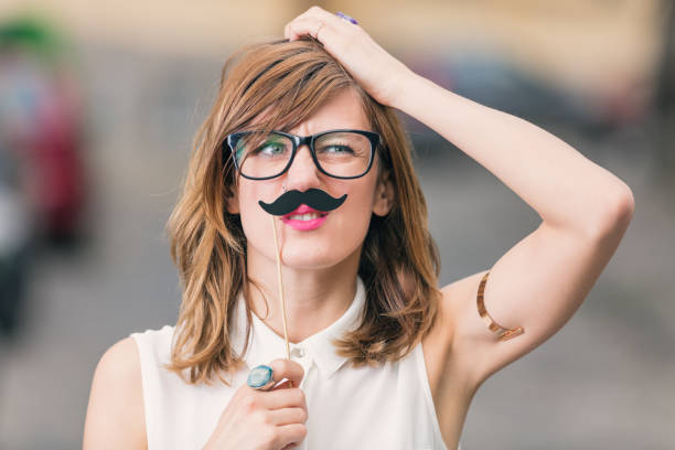 istock Girl pretending to be a man with mustache. 894966010