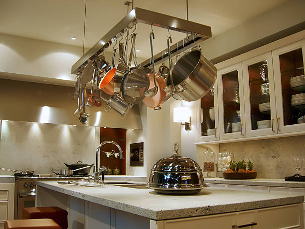 New, modern kitchen with a rack of hanging pots and pans stock photo