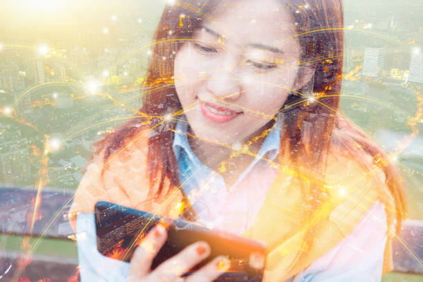 istock City network and young woman using smart phone 894977194