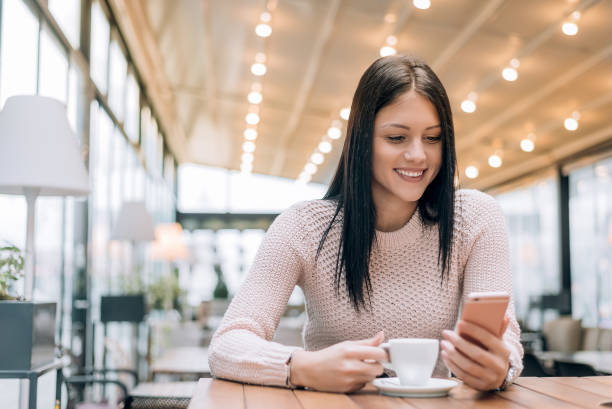 istock Young woman drinking coffee in a cafe,enjoying coffee break. 894977244