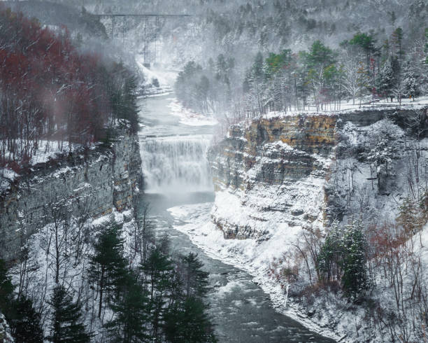 The view of Middle Falls from insparation point at Letchworth State Park The middle falls along the Genesee River inside the Letchworth State Park.   Taken the day after Thanksgiving after a heavy snow store.  Upper falls and the train bridge are also seen. letchworth state park stock pictures, royalty-free photos & images