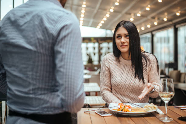 istock Disagreement between a waiter and a customer in a restaurant. 894980354