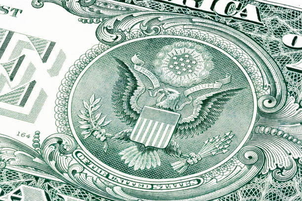istock Back of one dollar bill photo witch eagle. Stacked 894980544