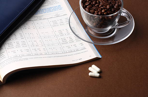 report and cup of coffee beans stock photo