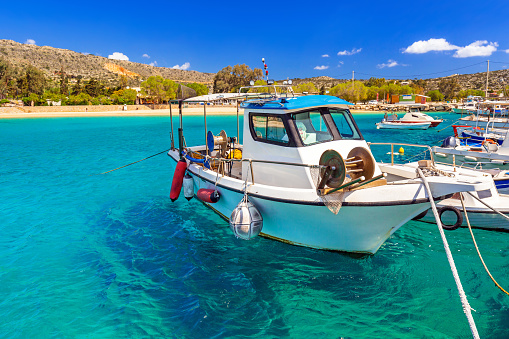 Blue lagoon of Marathi bay with fishing boats on Crete, Greece