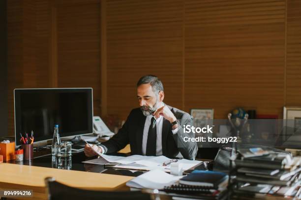 Senior Businessman Working On Laptop In Modern Office Stock Photo - Download Image Now