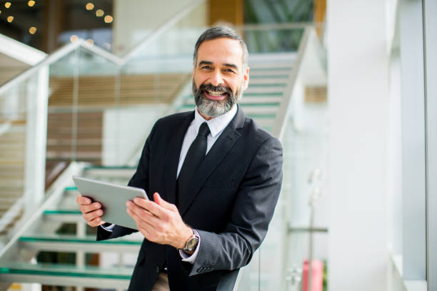 istock Middle age businessman with tablet in the office 894994238