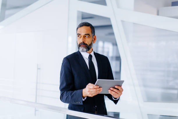 istock Middle age businessman with tablet in the office 894994726
