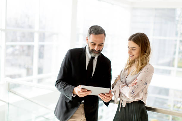 istock Business couple with digital tablet in office 894997062