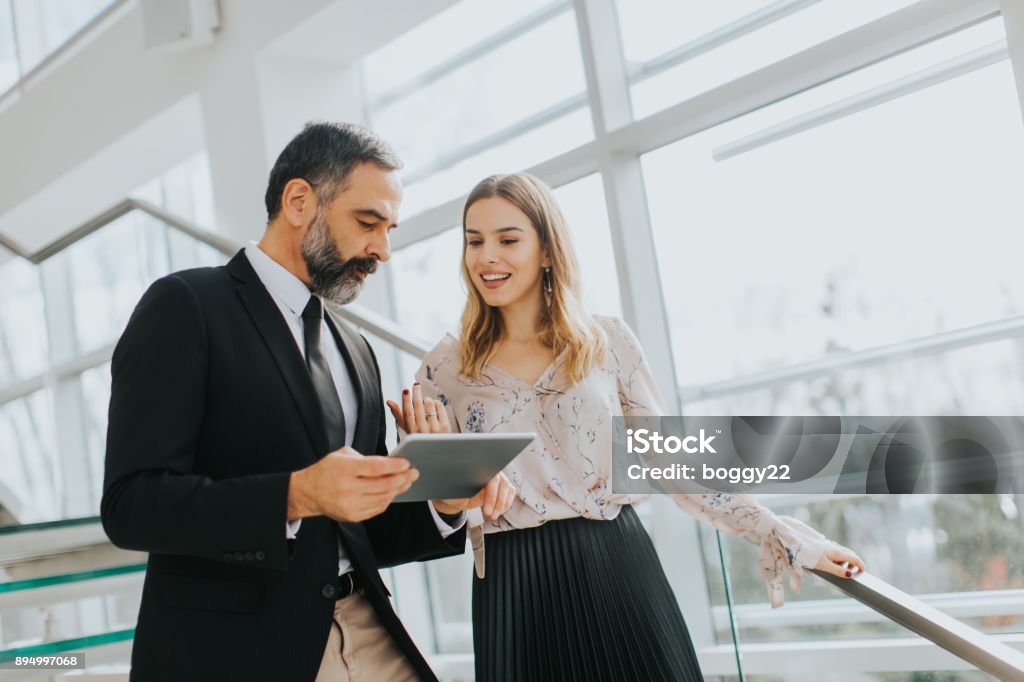 Business couple with digital tablet in office Portrait of business couple with digital tablet in office Business Stock Photo