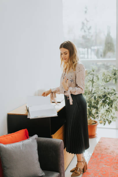 istock Young businesswoman looking at document 894997110