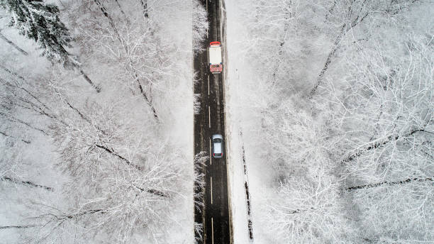 istock Road through wintery forest - aerial view 894997810