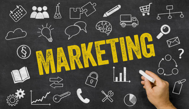 istock Marketing written on a blackboard with icons 895000374