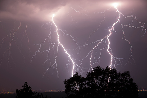 Night shot of stunning lightning strikes over non-urban landscape