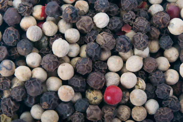 istock background of multi-colored pepper peas scattered, close-up 895018342