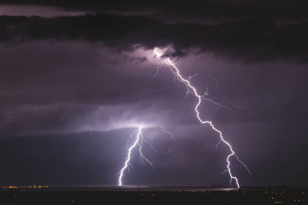 istock Colorful lightning strikes over sea 895021000